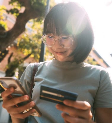 Woman holding her phone and credit card