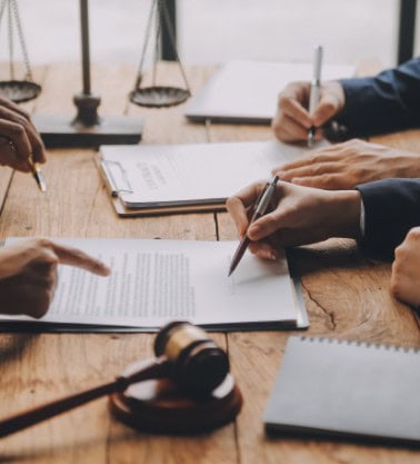 people reading through and signing documents